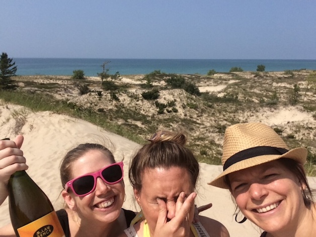 After trekking through the woods (and sea of mosquitoes) to the beach at Leelanau State Park, there is no better way to celebrate than setting down at a scenic overlook with a bottle of Mawby. To commemorate the occasion, we took this selfie. It was a really bright day. - Sarah