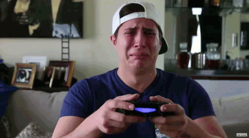 video gamer sobbing hysterically while using controller frantically